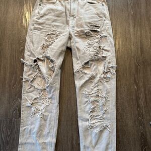Woman’s Distressed Light Gray Ripped Jeans